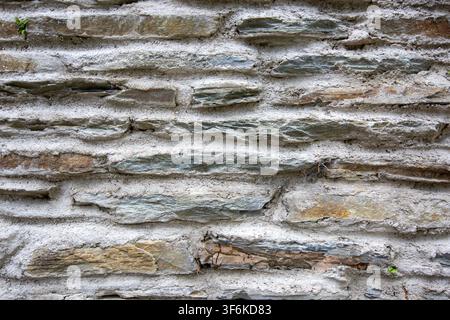 Close up texture of a traditional stone wall with thick mortar joints and layered natural stones in Jajce, Bosnia and Herzegovina Stock Photo