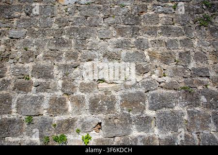 Full frame texture of an ancient medieval castle wall made of weathered ashlar stone blocks in Jajce, Bosnia and Herzegovina Stock Photo
