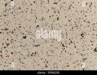 Beige composite material surface texture with black and terracotta flecks Stock Photo