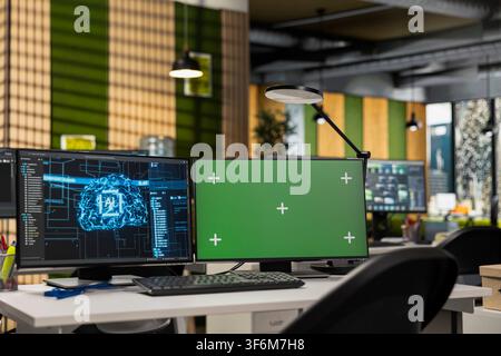 Green screen PC displays on startup office desk showing machine learning programming languages written by engineers. Chroma key computers in AI company used for code testing and quality assurance Stock Photo