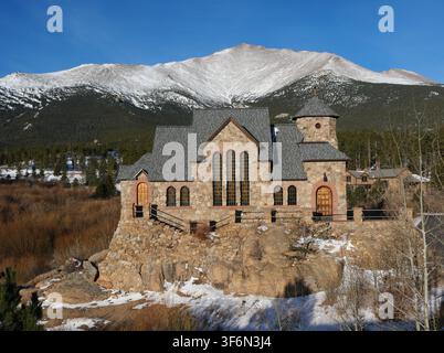 Saint Catherine's Chapel on the Rock beneath snow-covered Mount Meeker along the Peak to Peak Highway, Colorado, in winter. Stock Photo