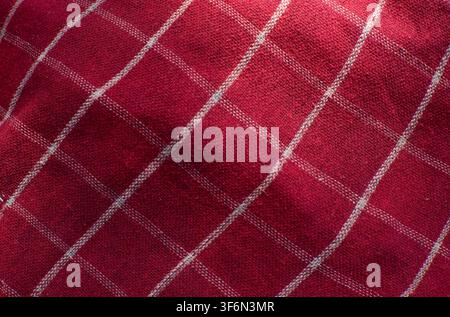 Red Checkered Fabric Texture Background With Diagonal Folds Stock Photo