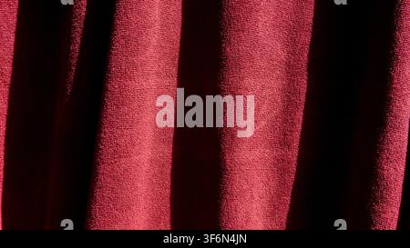 Close-up of red folded fabric with strong shadows Stock Photo