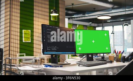 Technology company workspace with chroma key computer used to conduct code reviews, fixing bugs. Isolated screen PC on office desk used to design and implement algorithms Stock Photo