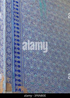 KHIVA, UZBEKISTAN - SEP 14, 2024 - Ancient blue-and-white tilework on a Khiva building facade showing intricate Islamic geometric patterns, texture an Stock Photo