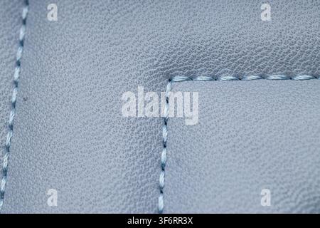 Light blue textured fabric with visible stitching detail, textile background and material texture Stock Photo