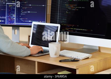 Female programmers hands testing code on laptop in office Stock Photo