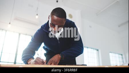 Architect, writing and black man in office with plan, design review and draft of renovation project. Development, below and engineer with notes Stock Photo