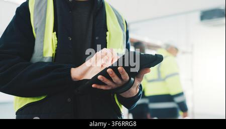 Construction, review or hands on site with tablet, task brief or inspection report on development. Industrial, man or engineer with tech, project Stock Photo