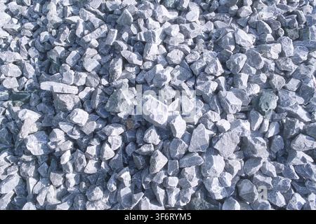 A close-up view of a large pile of smooth gravel rocks, arranged in an intricate textured pattern. The image showcases the natural variation and unifo Stock Photo