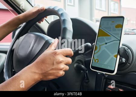 Female Hands Driving Car Using Smartphone GPS Navigation Map Stock Photo