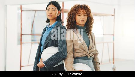 Construction, portrait and people on site with helmet, development team or pride in architecture. Serious, women or engineer in building with ppe Stock Photo