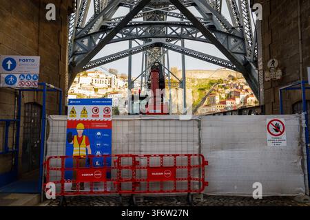 Lisboa, Janeiro 08, 2022: Construction works underway on the dom luís i bridge with safety signs and city background. Stock Photo
