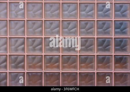 A translucent glass block wall is providing privacy at a modern architectural building. Stock Photo