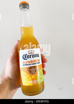 Hand holding a glass bottle of Corona Sunbrew Citrus Cerveza non-alcoholic beer - August 06, 2026 Puyallup WA, USA Stock Photo