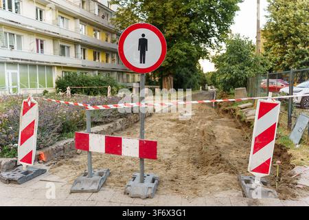 No pedestrian traffic sign at a construction site with red and white warning barriers, indicating a restricted and closed pathway for safety Stock Photo