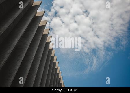 Repeating architectural fins against a blue sky Stock Photo