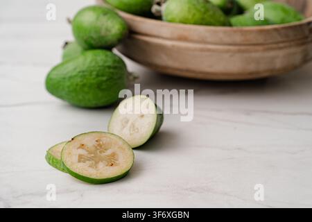Fresh feijoa fruit sliced on a countertop Stock Photo