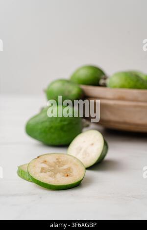 Fresh sliced feijoa fruits on a marble countertop Stock Photo