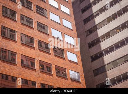 Red and grey brick building facades in sunlight Stock Photo