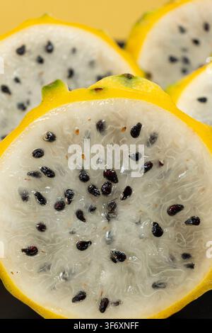 Cut ripe yellow pitahaya fruits close up view. Stock Photo