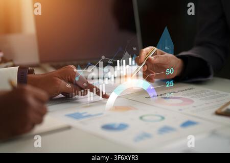 Business executives analyzing financial charts and digital growth data in corporate meeting Stock Photo