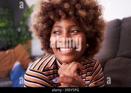 Smiling African American woman relaxing at home. Stock Photo