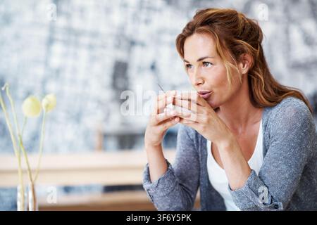 Woman, drinking or thinking with cup in cafe for remote work, ambition or small business startup. Thoughtful, female person or daydreaming with vision Stock Photo