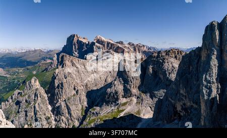 Aerial view of the rugged limestone peaks of the Dolomites, featuring dramatic rocky cliffs and steep slopes in San Martino di Castrozza, Trentino-Alt Stock Photo