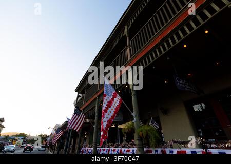 Historic multi story building in Mariposa decorated with American flags forward of Independence Day. Stock Photo