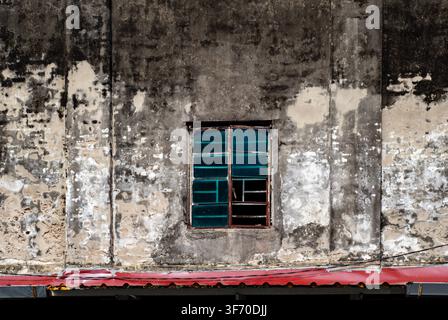 Old Weathered Concrete Wall with Vintage Green Window Frame Stock Photo
