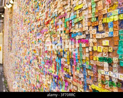 Colorful Wall of Handmade Ceramic Tiles with Close-up of a colorful wall covered with handmade ceramic letter tiles forming Armenian names in Gyumri, Stock Photo