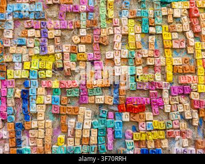 Colorful Wall of Handmade Ceramic Tiles with Close-up of a colorful wall covered with handmade ceramic letter tiles forming Armenian names in Gyumri, Stock Photo