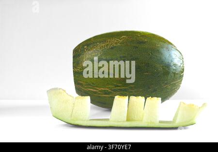 Melon. Cucumis melo, commonly called melon, is a species in the Cucurbitaceae family. It was domesticated more than four thousand years ago in the eas Stock Photo