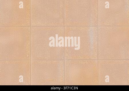 A full frame view of light brown beige square ceramic tiles with fine surface texture. Stock Photo