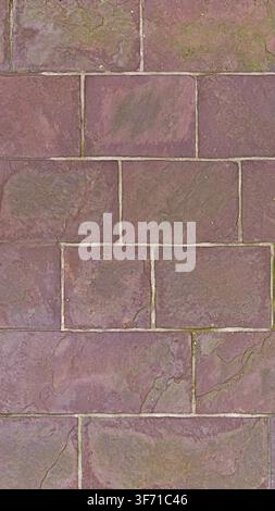 A full frame seamless texture of red stone rectangular paving tiles with natural rough surface. Stock Photo
