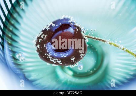 Fresh Cherry in Sparkling Mineral Water with Bubbles Macro Stock Photo