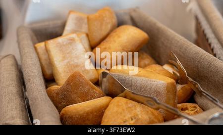 Fresh Bread Rolls in Basket at Hotel Breakfast Buffet Stock Photo