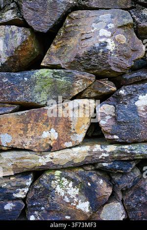 Close-up detail of colorful traditional hand crafted stone wall in rural Wales Stock Photo