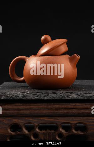 Traditional Clay Teapot Isolated on Dark Background Stock Photo