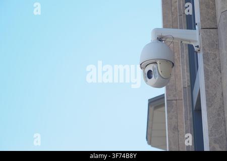 Security camera mounted on a building during the day Stock Photo