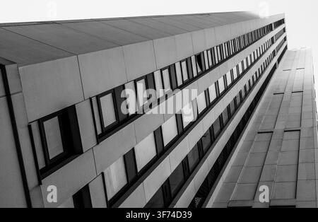Monotone low angle view looking up at a modern concrete office building Stock Photo