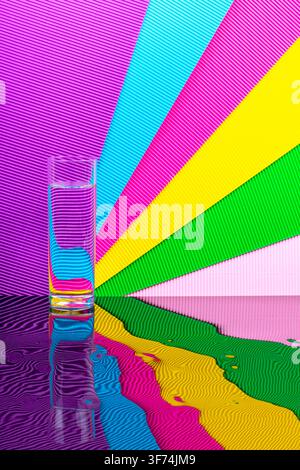 Abstract background with multicolored stripes and a glass of liquid Stock Photo