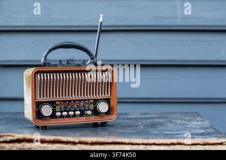 Vintage wooden retro radio receiver on wooden table Stock Photo