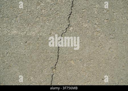 Detailed abstract background of aged and weathered road pavement surface showing small mineral Stock Photo