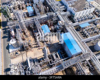 Aerial view of industrial pipe racks, cooling equipment, and ...