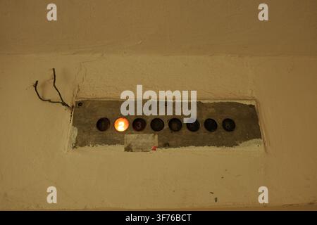 Old elevator floor indicator on a worn wall displaying the number two, signaling the current position of the car in a building, reflecting themes of r Stock Photo