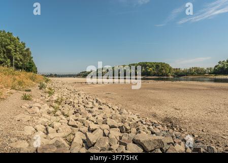 Dried up section of the Rhine River with stones and gravel during extreme summer drought, Germersheim, Germany Stock Photo