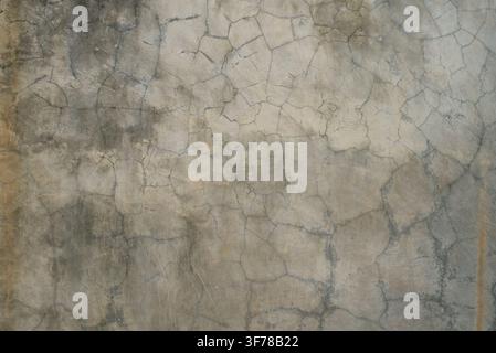 Cement wall texture with fine cracks. Industrial cement wall background with natural cracks Stock Photo