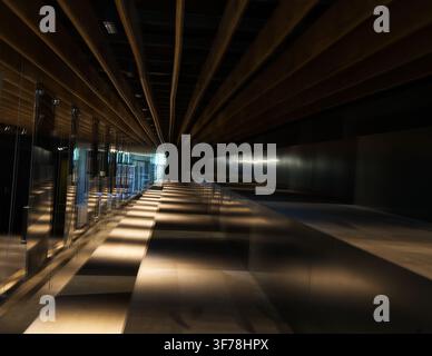 Dramatic interplay of light and shadow cast by slatted ceiling Stock Photo